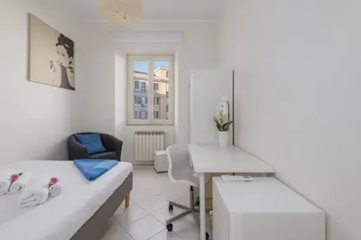 a bedroom with a bed and a desk and a table at Domus Aurea3 flat a stone's throw from Colosseum in Rome