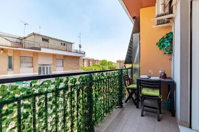 a balcony with a table and chairs on a fence at GuestHost - La Rosa di Trastevere in Rome