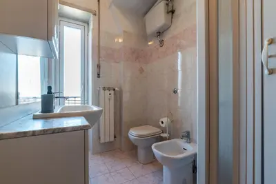 a bathroom with a toilet and a sink at GuestHost - La Rosa di Trastevere in Rome