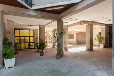 an empty lobby with potted plants in a building at GuestHost - La Rosa di Trastevere in Rome