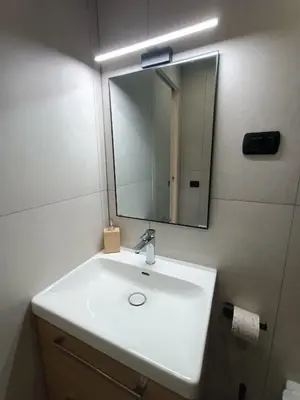 a bathroom with a white sink and a mirror at World Wide Bed Termini in Rome