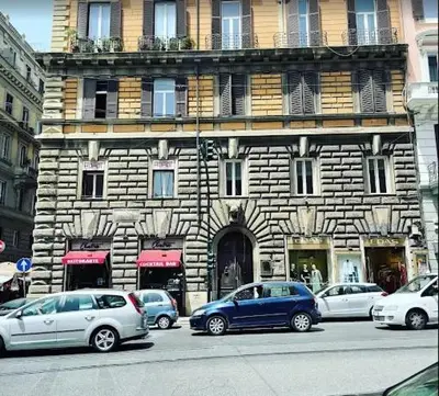 a building with cars parked in front of it at World Wide Bed Termini in Rome