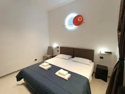 a bedroom with a bed with two towels on it at World Wide Bed Termini in Rome