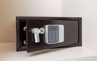 a safe with a remote control and a cell phone at Interno2 - Cozy flat near Vatican Museums in Rome
