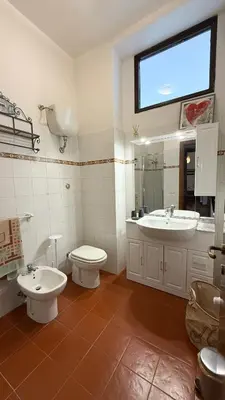 a bathroom with a sink and a toilet and a sink at Borgo Una Casa Nel Vicolo in Rome
