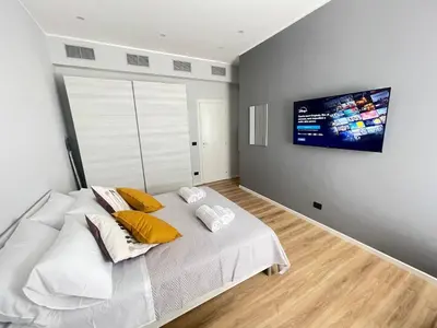 a bedroom with a bed with a tv on the wall at Basilica San Giovanni Appia Antica At a Friends House in Rome