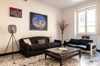 a living room with a couch and a table at Bright and spacious flat in the hearth of Rome in Rome