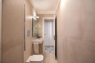 a bathroom with a toilet and a sink at Bright and spacious flat in the hearth of Rome in Rome