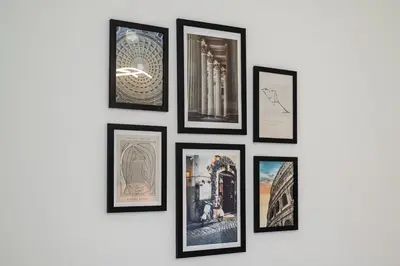 a group of framed pictures on a wall at Rome Centre - Spacious Apartment - Jacuzzi - AC - WiFi in Rome
