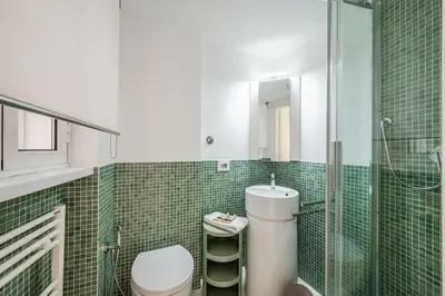 a bathroom with a toilet and a glass shower at Rome Centre - Spacious Apartment - Jacuzzi - AC - WiFi in Rome