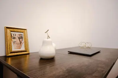 a table with a white vase and a picture at Suite Vaticano in Rome