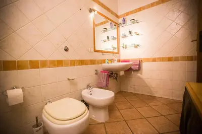 a bathroom with a toilet and a sink at Casetta Ponte Milvio in Rome