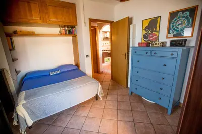 a bedroom with a bed and a blue dresser at Casetta Ponte Milvio in Rome