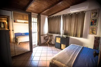 a bedroom with a bed and a desk in a room at Casetta Ponte Milvio in Rome