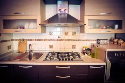 a kitchen with a stove and a sink at Casetta Ponte Milvio in Rome