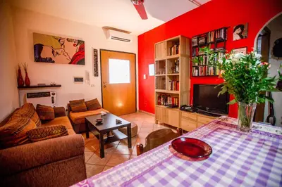a living room with red walls and a couch and a table at Casetta Ponte Milvio in Rome