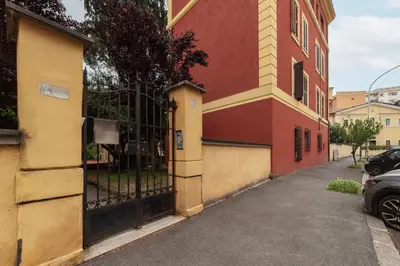 a building with a gate on the side of a street at GuestHost - Cozy Apartment near Tiburtina in Rome
