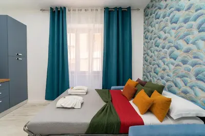 a bedroom with a large bed with blue curtains at Jhonny's Apartment Near Vatican 3 bedroom's in Rome