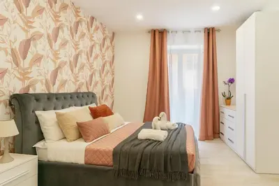 a bedroom with a bed with a teddy bear on it at Jhonny's Apartment Near Vatican 3 bedroom's in Rome