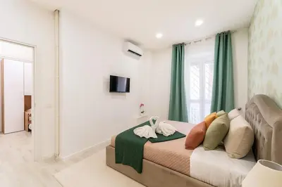 a bedroom with a bed with pillows on it at Jhonny's Apartment Near Vatican 3 bedroom's in Rome