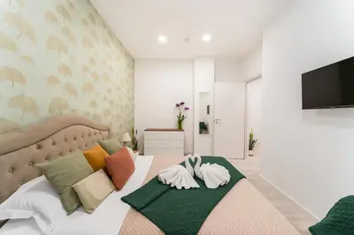 a bedroom with a large bed with colorful pillows at Jhonny's Apartment Near Vatican 3 bedroom's in Rome