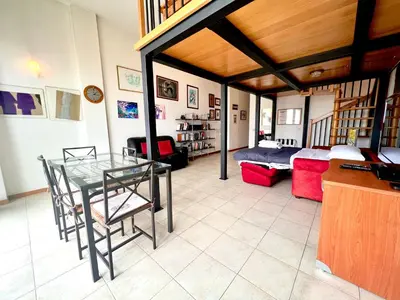 a bedroom with a loft bed and a living room at Loft Pantanella Porta Magiore in Rome