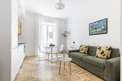 a living room with a couch and a table at Hostly-The Montebello Suite-Near Trevi in Rome