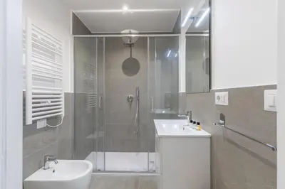 a bathroom with a shower and a toilet and a sink at Hostly-The Montebello Suite-Near Trevi in Rome