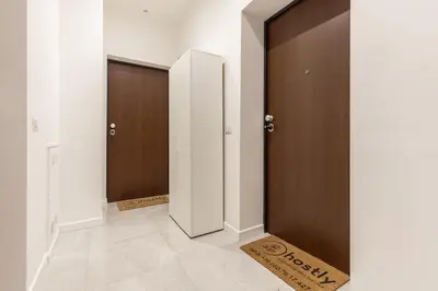a hallway with two doors and a rug on the floor at Hostly-The Montebello Suite-Near Trevi in Rome