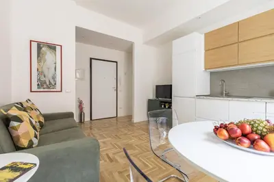 a living room with a couch and a table with a bowl of fruit at Hostly-The Montebello Suite-Near Trevi in Rome