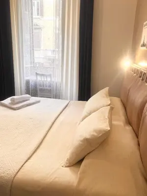 a bed with two pillows sitting in front of a window at Guest house Aria in Rome