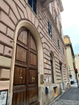 a large wooden door on the side of a building at Guest house Aria in Rome