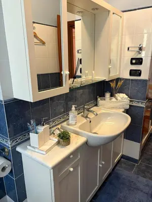 a bathroom with a sink and a mirror at San Pietro Street 9 in Rome