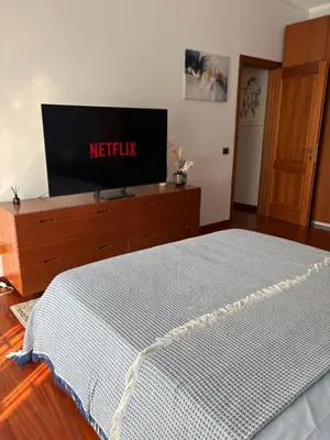 a bedroom with a bed and a tv on a dresser at San Pietro Street 9 in Rome
