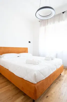 a bedroom with a large bed with white sheets at Home d'élite Gregory in Rome