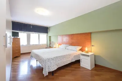 a kitchen with white cabinets and a sink at Green Home Caravaggio in Rome