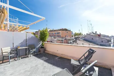 a balcony with chairs and a table on a building at Rarity Suites in Rome