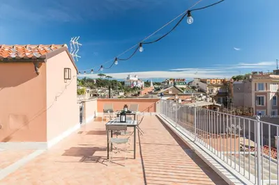 a balcony with a table and chairs on a building at Rarity Suites in Rome