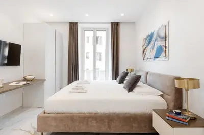 a bedroom with a large bed and a couch at Eternal House Caulonia in Rome