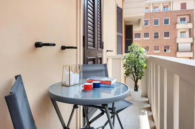 a blue table and chairs on a balcony at Eternal House Caulonia in Rome