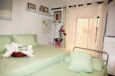 a room with a bed with a basket and a window at La casetta di Brigida in Rome