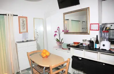 a kitchen with a table with a bowl of fruit on it at La casetta di Brigida in Rome