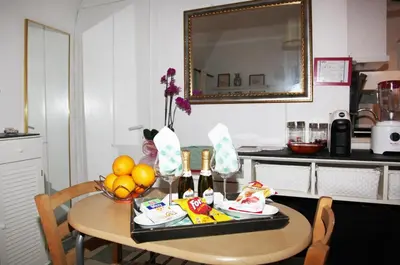 a table with a bowl of fruit and a mirror at La casetta di Brigida in Rome