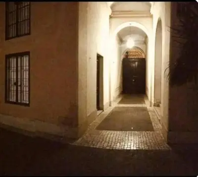 an empty hallway of a building with a black door at La casetta di Brigida in Rome