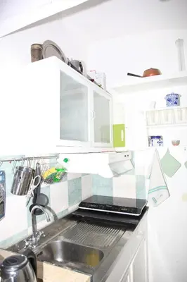 a kitchen with a sink and a laptop on the counter at La casetta di Brigida in Rome