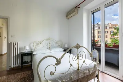 a white bed in a room with a window at La Casa di Edo in Rome
