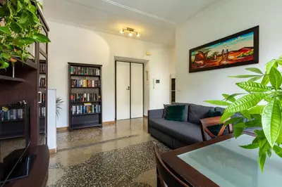 a living room with a couch and a book shelf at La Casa di Edo in Rome