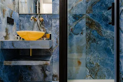 a bathroom with a yellow sink and blue tiles at Historical Center in Rome