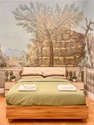 a bedroom with a bed with two towels on it at Historic Fresco Suite Rome Colosseum Boutique Stay in Rome