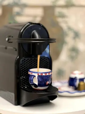 a coffee maker with a cup on a counter at Historic Fresco Suite Rome Colosseum Boutique Stay in Rome